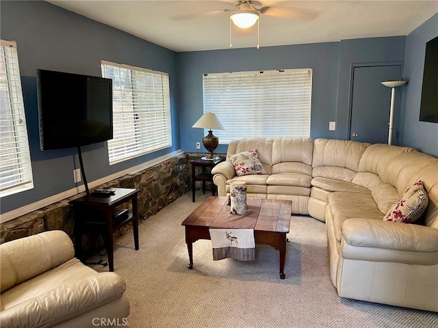 living area with carpet flooring and a ceiling fan