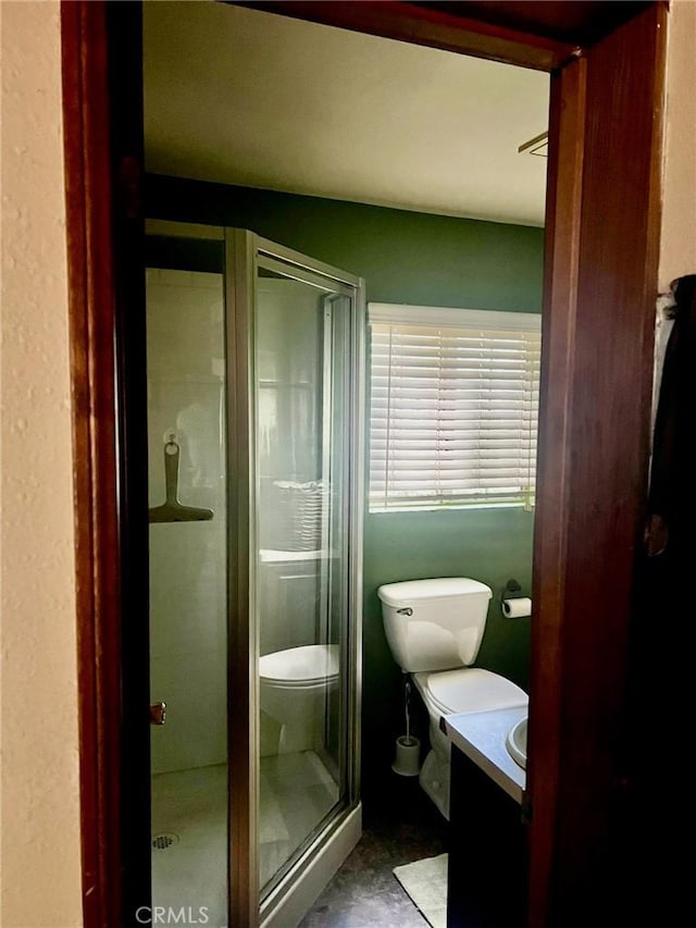 full bathroom featuring vanity, toilet, and a stall shower