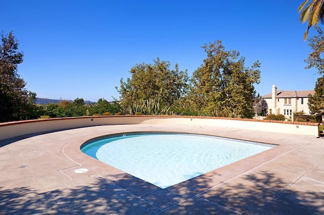 view of swimming pool featuring a patio and a pool