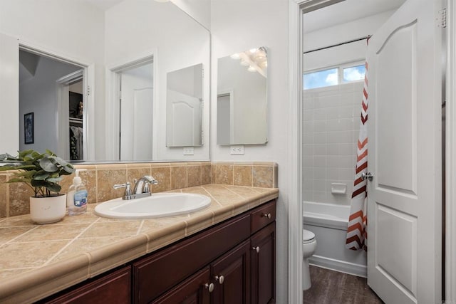 full bath featuring vanity, shower / bath combo, toilet, and wood finished floors