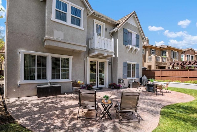 2258 Aventurine Pl, Carlsbad, CA 92009 - back of property with a balcony, stucco siding, and french doors