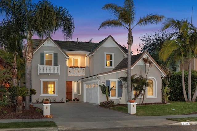 2258 Aventurine Pl, Carlsbad, CA 92009 - view of front facade featuring a balcony, concrete driveway, stucco siding, and a yard