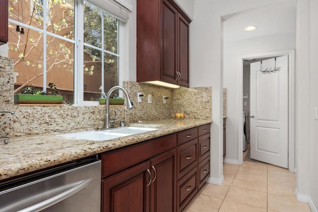 2258 Aventurine Pl, Carlsbad, CA 92009 - kitchen with dishwasher, a sink, washer / dryer, baseboards, and decorative backsplash
