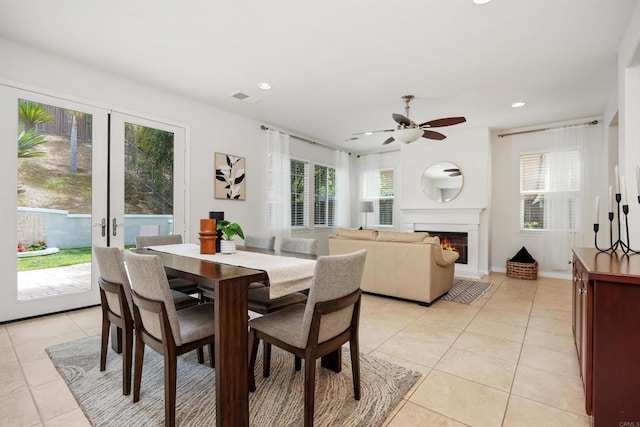 2258 Aventurine Pl, Carlsbad, CA 92009 - dining room with light tile patterned flooring, a ceiling fan, a glass covered fireplace, recessed lighting, and french doors