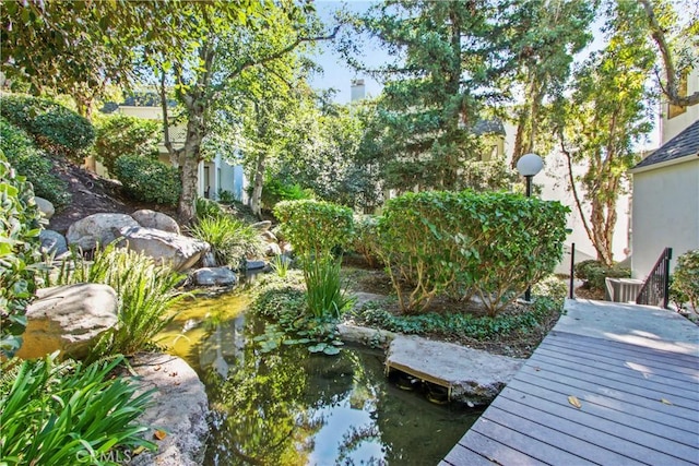 view of dock with a small pond