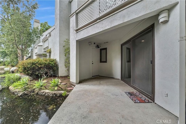 property entrance with stucco siding
