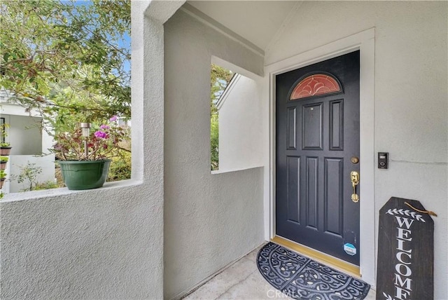 doorway to property with stucco siding