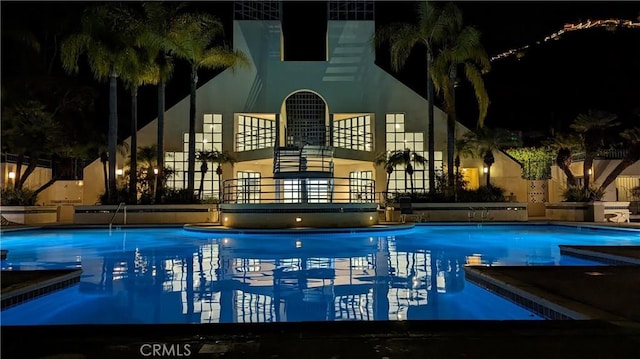 pool at twilight featuring a community pool