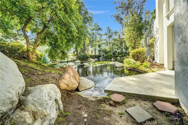 exterior space with a garden pond