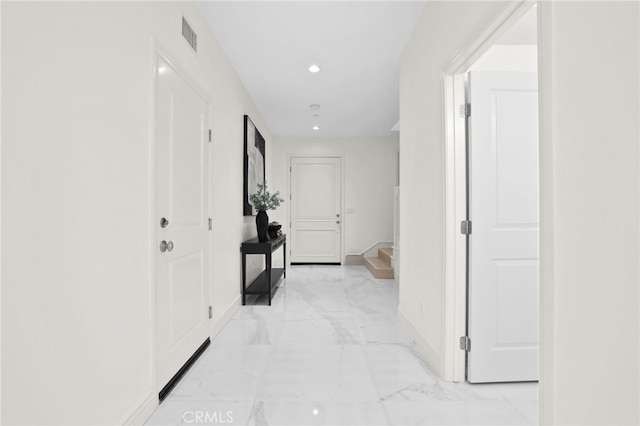 hallway with baseboards, recessed lighting, marble finish floor, and visible vents