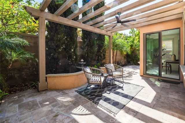 view of patio with fence, a ceiling fan, and a pergola