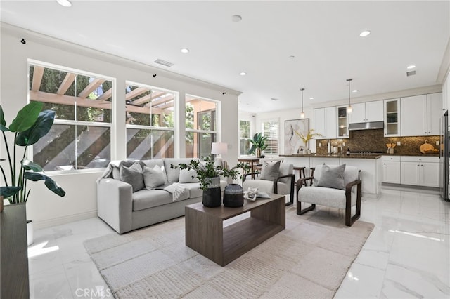 living room featuring recessed lighting, visible vents, and marble finish floor