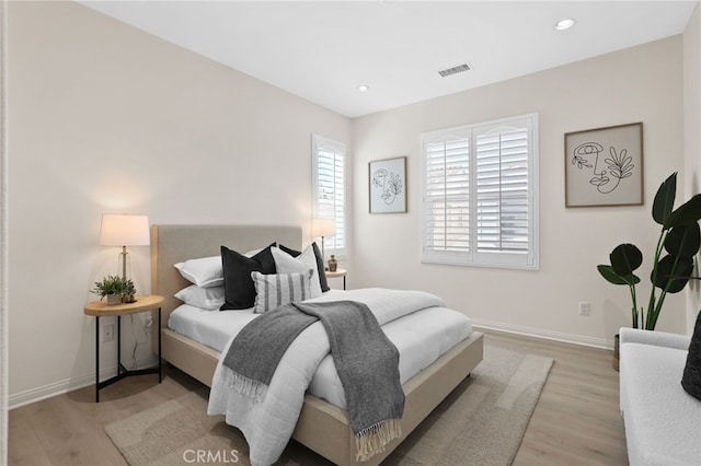 bedroom with visible vents, recessed lighting, baseboards, and wood finished floors
