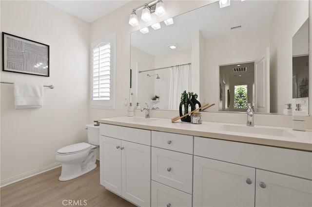 bathroom featuring visible vents, a wealth of natural light, and a sink