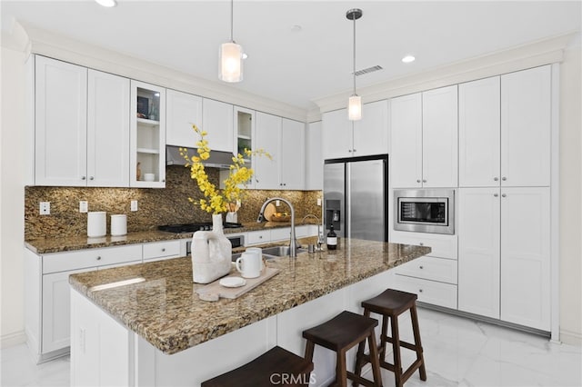 kitchen featuring stainless steel appliances, glass insert cabinets, a sink, and marble finish floor