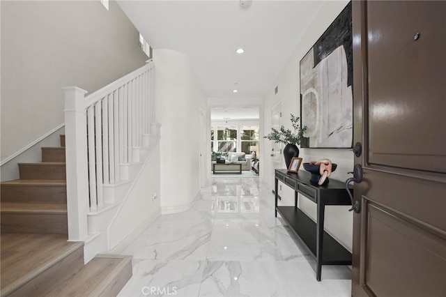 foyer with recessed lighting, marble finish floor, stairs, and baseboards
