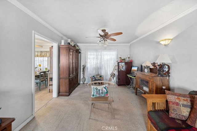 living room with ornamental molding, a ceiling fan, and light colored carpet