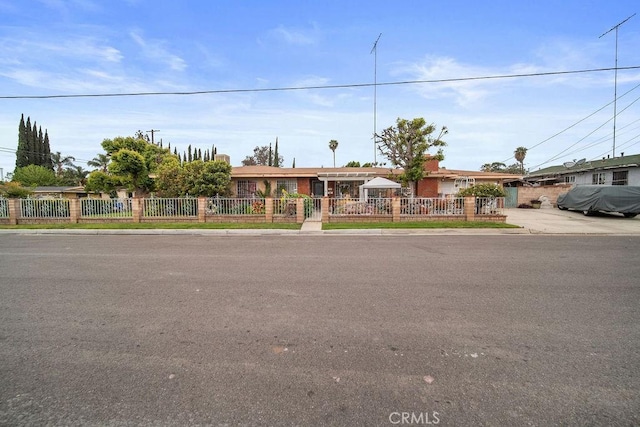 ranch-style house with a fenced front yard