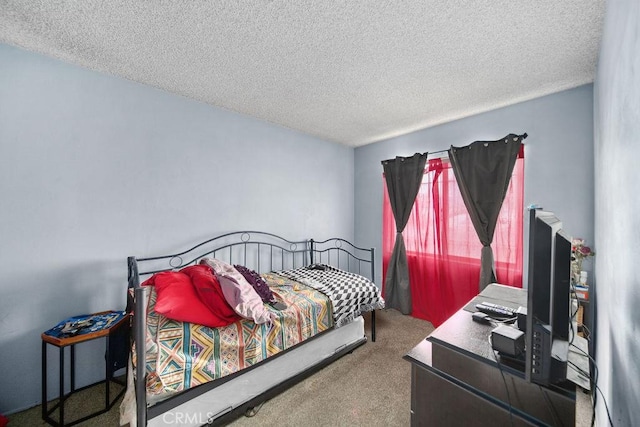bedroom featuring carpet flooring and a textured ceiling