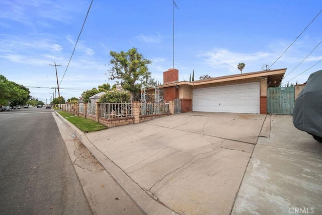 single story home with fence, an attached garage, driveway, and brick siding