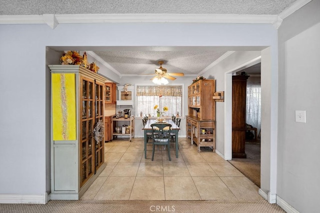 dining room featuring ornamental molding, a textured ceiling, and a ceiling fan