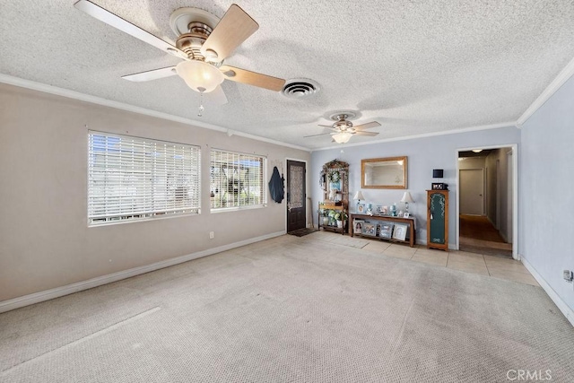 carpeted empty room featuring a ceiling fan, a textured ceiling, visible vents, crown molding, and baseboards