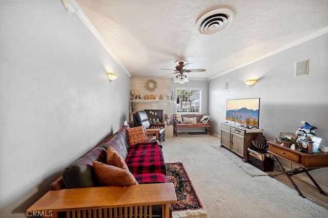 living area with ceiling fan, a textured ceiling, visible vents, crown molding, and light colored carpet