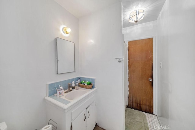 bathroom featuring tasteful backsplash and vanity