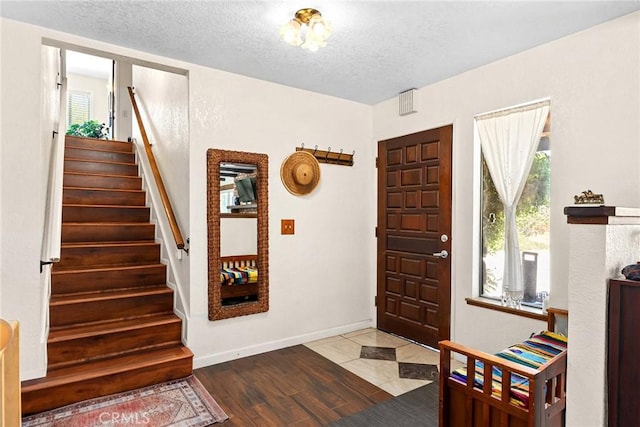 26231 Wilson St, Los Molinos, CA 96055 - entrance foyer with a textured ceiling, baseboards, stairway, and wood finished floors