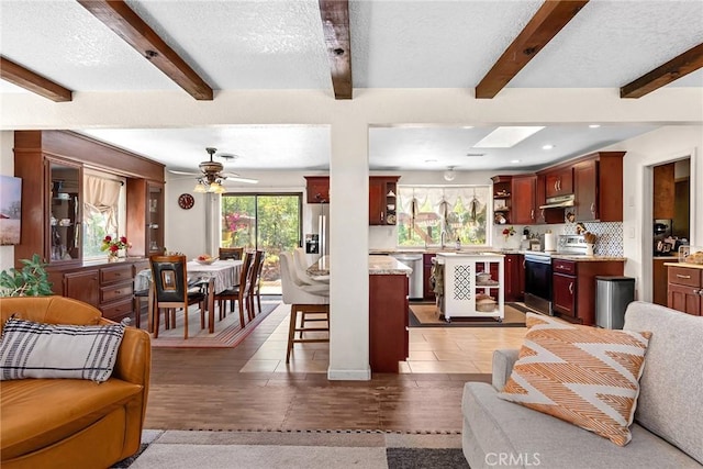 26231 Wilson St, Los Molinos, CA 96055 - living area with a ceiling fan, a textured ceiling, beam ceiling, light wood finished floors, and recessed lighting