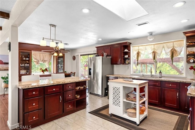 26231 Wilson St, Los Molinos, CA 96055 - kitchen with open shelves, dark brown cabinets, stainless steel refrigerator with ice dispenser, a sink, and decorative light fixtures