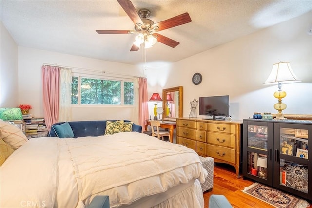 bedroom featuring ceiling fan and wood finished floors
