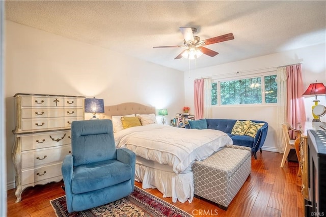 bedroom featuring a textured ceiling, ceiling fan, and hardwood / wood-style floors