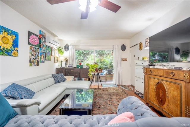 living area featuring wood finished floors, ceiling fan, and a wall unit AC
