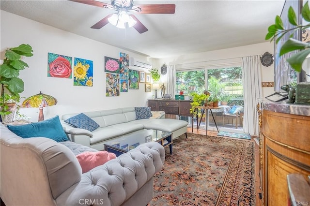 living room with an AC wall unit and ceiling fan