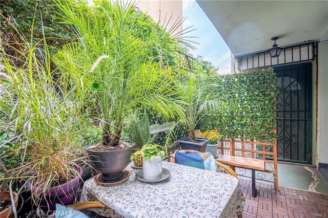 balcony with outdoor dining space and a patio area