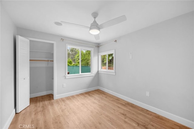 unfurnished bedroom with a closet, light wood-style floors, and baseboards
