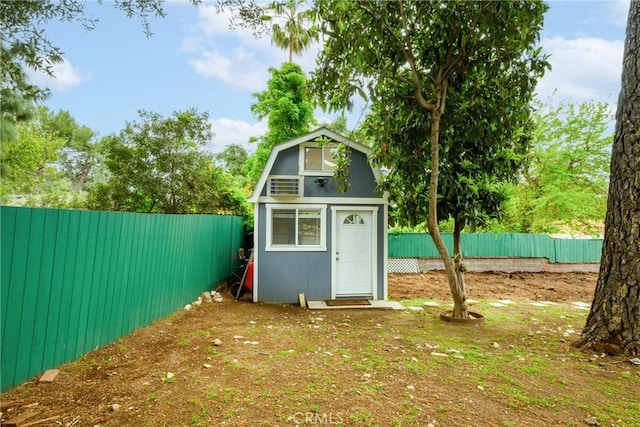 view of outbuilding featuring an outdoor structure and a fenced backyard