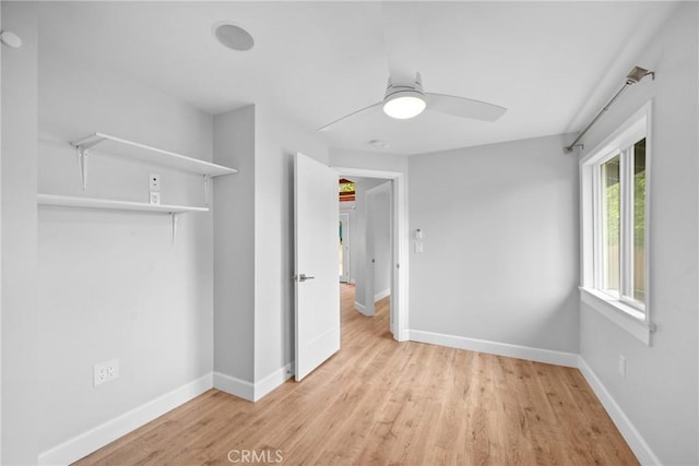 unfurnished bedroom with baseboards, ceiling fan, and light wood-type flooring