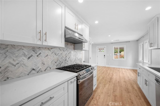 kitchen with decorative backsplash, baseboards, recessed lighting, under cabinet range hood, and appliances with stainless steel finishes