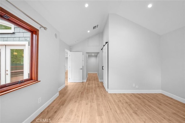 interior space with recessed lighting, vaulted ceiling, light wood finished floors, and visible vents