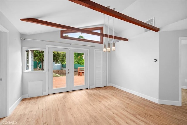 interior space featuring lofted ceiling with beams, french doors, and wood finished floors