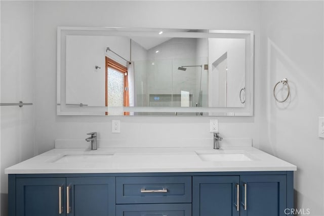 full bath featuring double vanity, a sink, and a stall shower