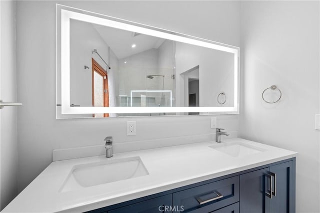 full bathroom featuring a sink, a shower stall, and double vanity