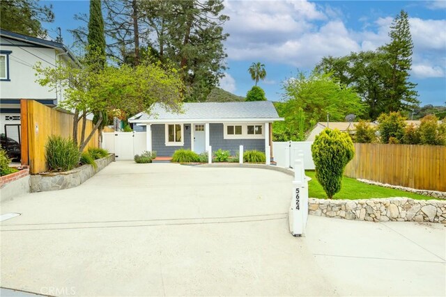 view of front of property featuring fence private yard and a gate