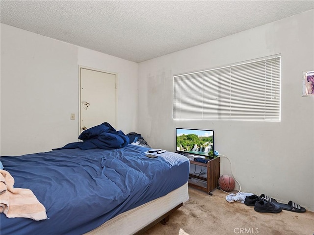 bedroom featuring carpet floors and a textured ceiling