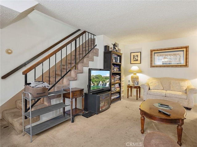 living area with stairs, a textured ceiling, and carpet flooring