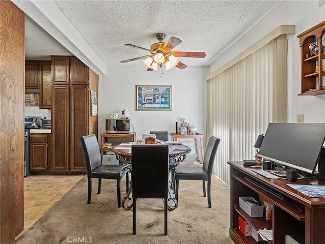 dining room with a ceiling fan and a textured ceiling