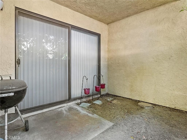 property entrance with stucco siding