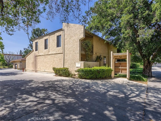 view of side of property featuring stucco siding